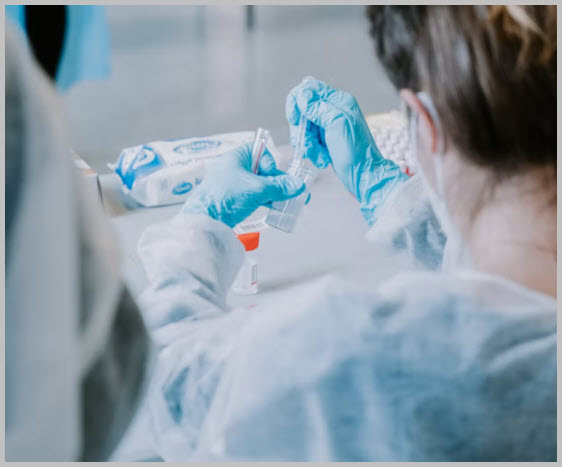 Laboratory professional handling a clinical sample